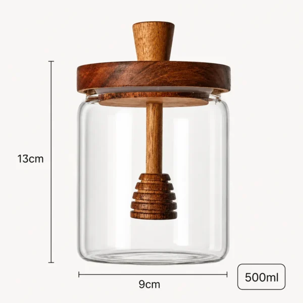 Transparent honey jar with wooden honey spoon and lid